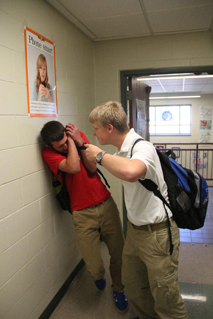 Junior Chris Golab holds sophomore Adam Wolf up to a wall for trying to use the “junior hallway”. A select few juniors have known to torture underclassman because of their major misconception that there actually is a “junior hallway”.