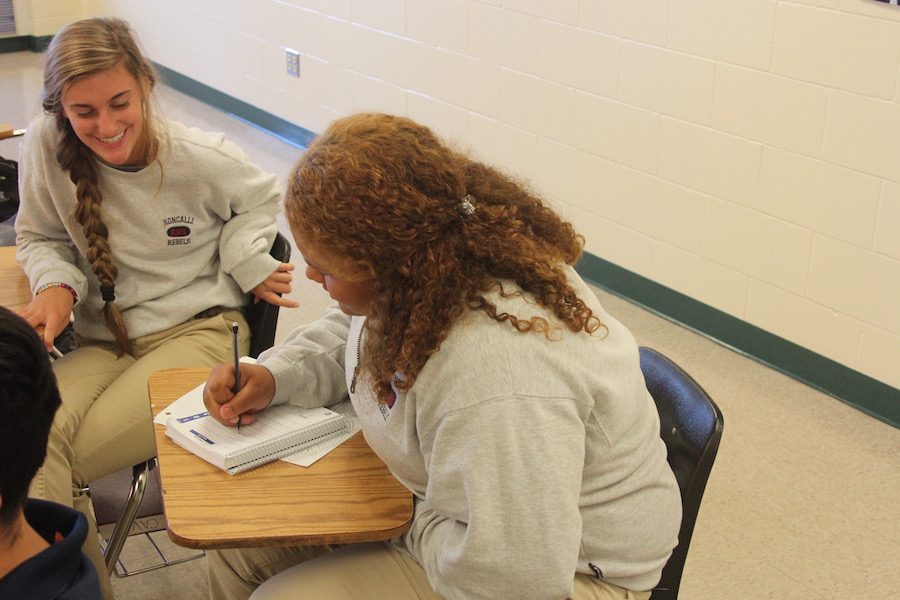 Planning ahead: Juniors Autumn Peoni and Sophia Ray write down assignments in their planners. Making use of planners is a great way to get ahead in school.