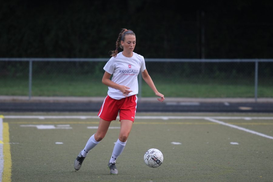 Josie Asher warms up for a game at Roncalli High School against Plainfield High School on August 30.  This game was later cancelled due to serious weather conditions.