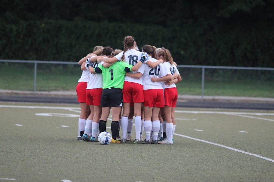 HUDDLE UP: The Lady Rebels huddled before their senior night game against Southport.  They won 5-0 and later advanced to Sectionals, where they won both games.