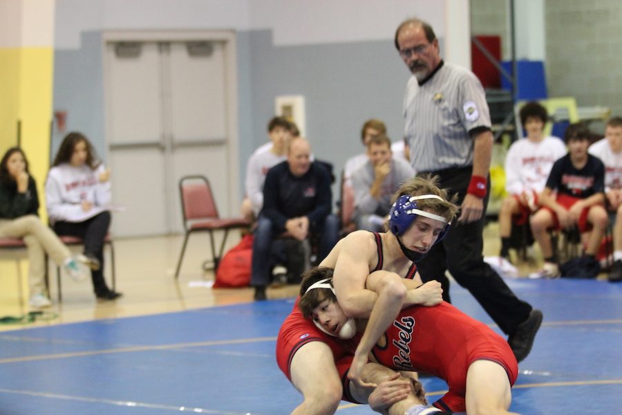Freshman Alec Viduya tries to pin down sophomore Jarrod Shanley during a meet at Roncalli High School. 