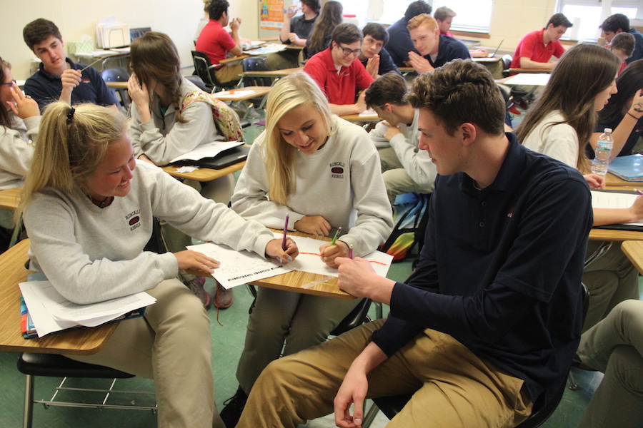 FOCUSED: Seniors Katie Griffin, Maddie Ganka, and Jackson McHugh work together on a math project. Along with keeping grades up, all three balance jobs and other activities as well.
