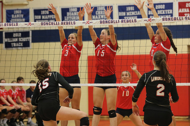 BUMP%2C+SET%2C+SPIKE%3A+Sophomore+Abby+Johnson+%28%233%29%2C+junior+Elizabeth+Eads+%28%2315%29%2C+and+freshman+Miranda+Wilson+%28%238%29+block+a+spike+against+the+Lawrence+North+Wildcats.+The+Rebels+lost+the+game+in+five+sets.