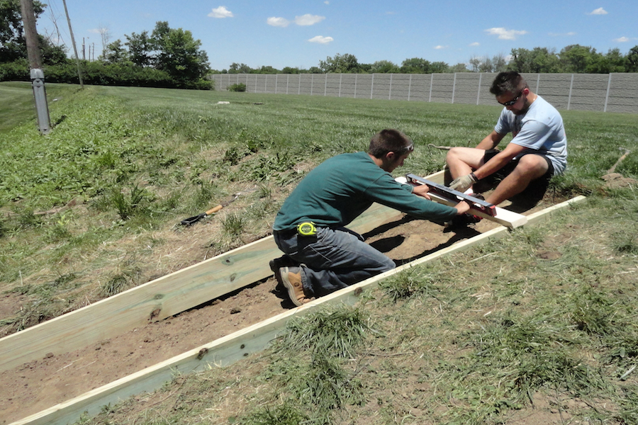 BACK-BREAKING+WORK%3A+Senior+Jason+Brown+and+alumnus+Mark+Jones+steady+the+level+as+they+prepare+to+mount+down+the+first+step+of+Brown%27s+Eagle+Scout+project.+On+August+17th%2C+Brown+was+accepted+by+the+Scouting+Board+and+officially+named+an+Eagle+Scout.+