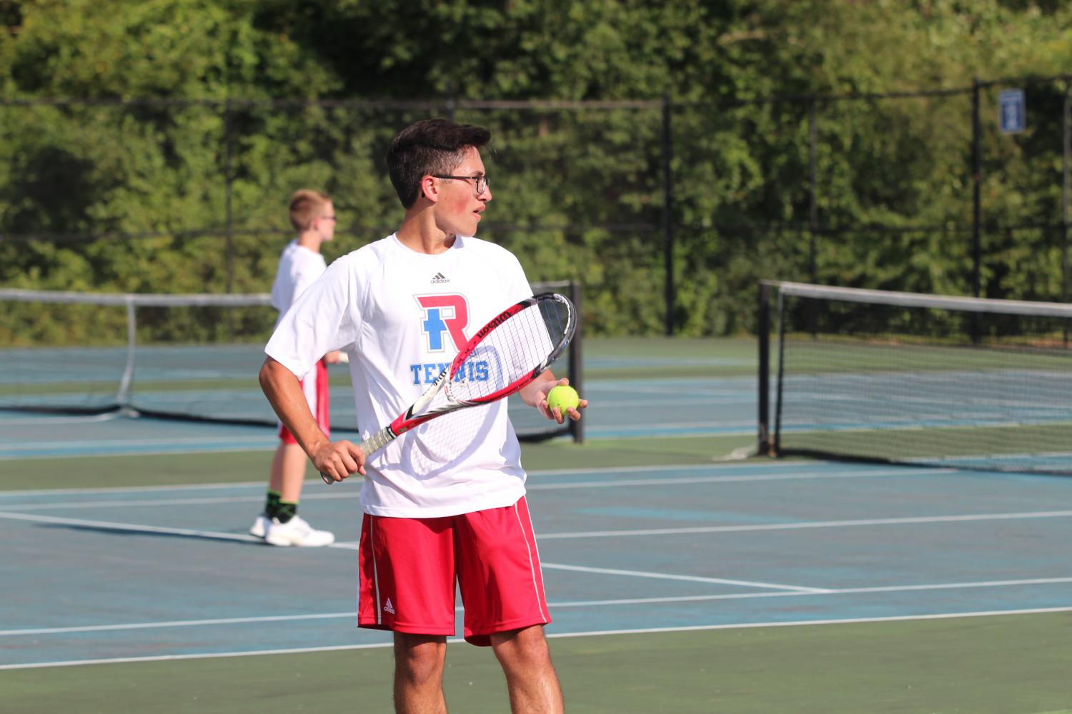 FOCUS AND FORM: Senior Alex Ruble prepares to serve in his first match of the season. The Rebels defeated Franklin Central with a combined score of 3-2.