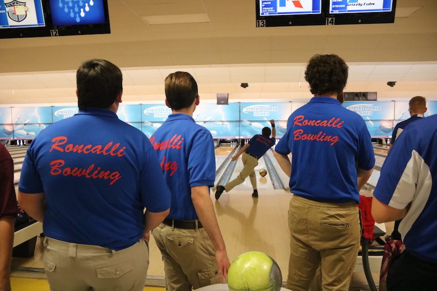 STAY IN YOUR LANE: The Roncalli boys' bowling team stands by as sophomore Trace Solonka warms up for the match. This was the boys' first bowling match at Strike Force Lanes against Franklin Community.