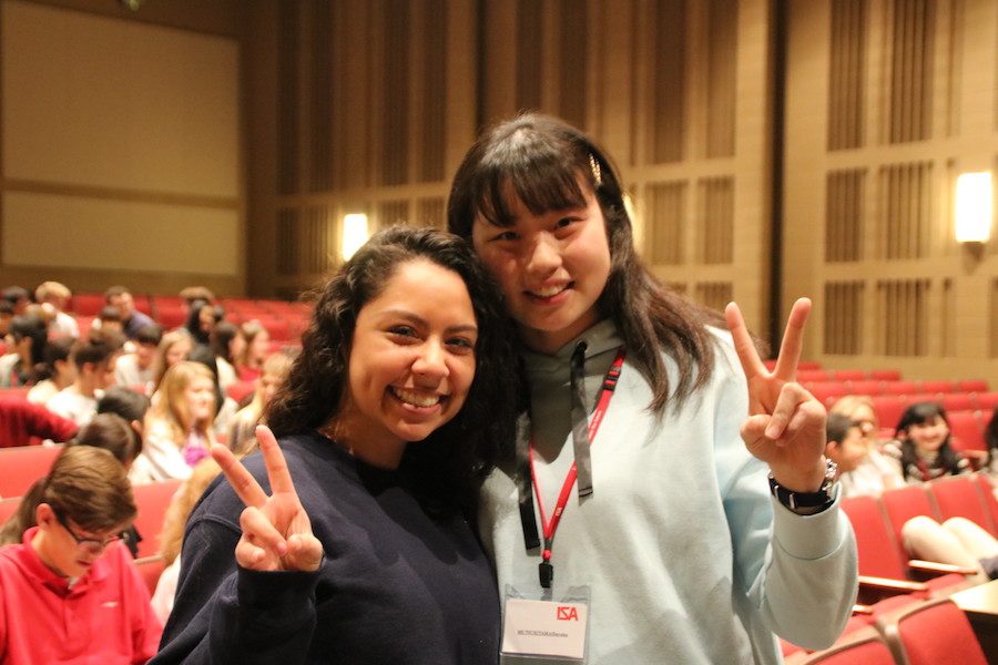 PEACE+OUT%3A+Junior+Beatriz+Venegas+and+her+shadow+Sayaka+Tsukiyama+pose+with+peace+signs+for+a+photo.+The+two+girls+spent+the+day+sharing+laughs+before+saying+their+goodbyes+at+the+end+of+the+school+day.