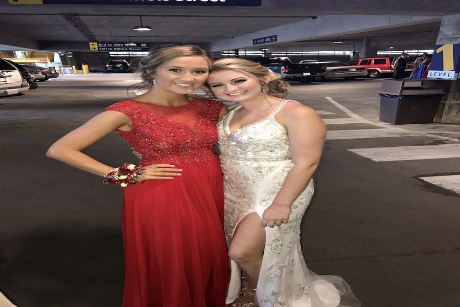 PRICEY PROM: Seniors Emma Barnett and Grace Silver posed at the prom last year, which was hosted at the Children’s Museum. This year’s prom will be held at Crane Bay, and the theme is masquerade. 

