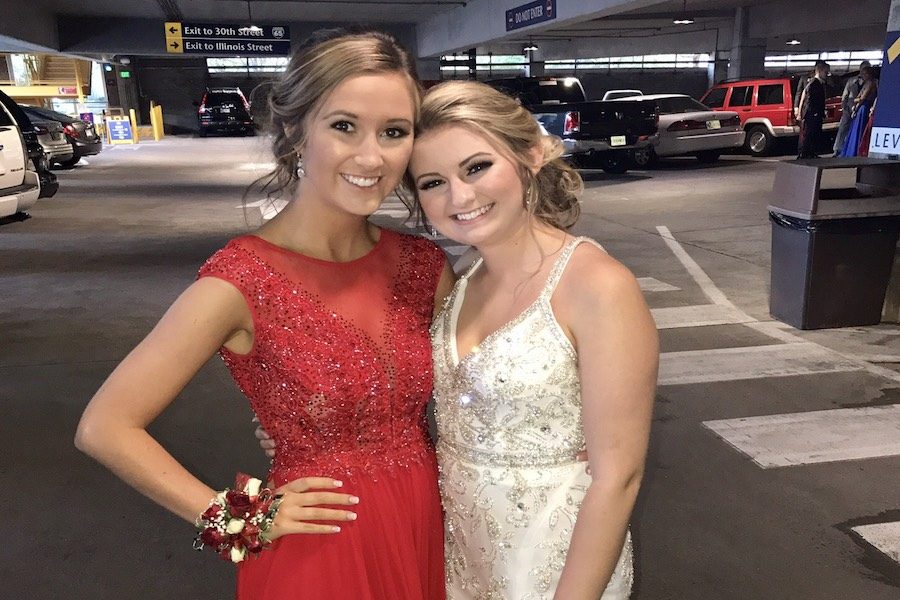 PRICEY PROM: Seniors Emma Barnett and Grace Silver posed at the prom last year, which was hosted at the Children’s Museum. This year’s prom will be held at Crane Bay, and the theme is masquerade. 