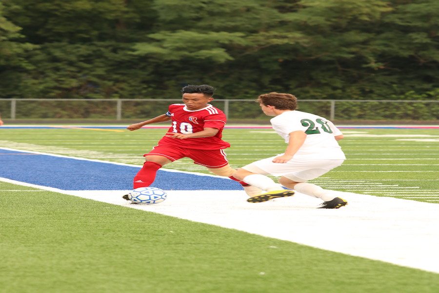 BRACE YOURSELVES: Robert Thang dribbles down the field in a game against Covenant Christian. Robert scored two goals for the Rebels and the team went on to win the game 4-1.
