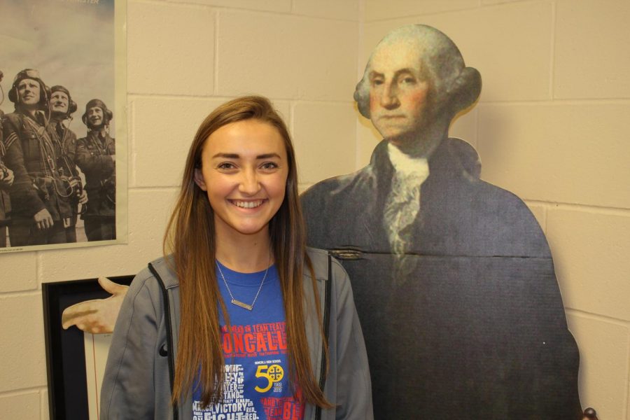 TRADITION OF EXCELLENCE: Maddie Mulinaro stands by her role model George Washington in her US History classroom. He was one of the first additions to her new classroom.