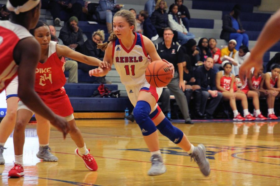 DRIVING IN THE PAINT:  Senior Alana Vinson dribbles the ball down the lane and finishes at the rim. Vinson completed the game with 21 points and nine rebounds. 
