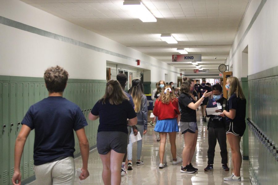 Freshman walk to their first period class. They receive help from seniors on where to go and will be greeted at their classroom by more students.