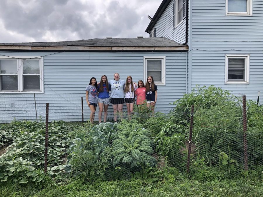 PLANTY PROJECT: Pictured above is Earth Club’s on-campus garden and its tenders. This work provides for the community and encourages green living.