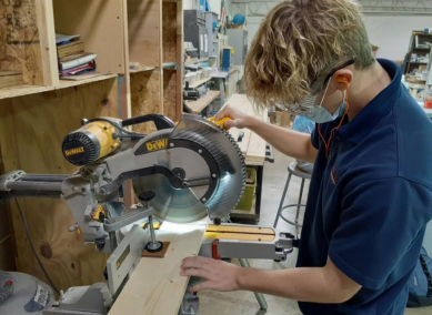 UNIQUE OPPORTUNITIES: Roncalli student Carter Chapman creating a birdhouse for service hours. The bird houses are then going to be painted and placed in a park. 