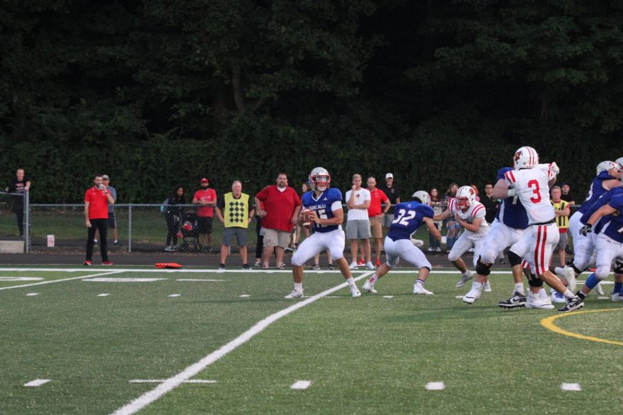 SEARCHING FOR SIX: Aidan Leffler (#15) looks to throw a touchdown pass to Kyle Lockard in week one against Southport, pushing himself further into the record books for most career touchdown passes. The teams week one win against Southport began their journey towards an undefeated regular season.