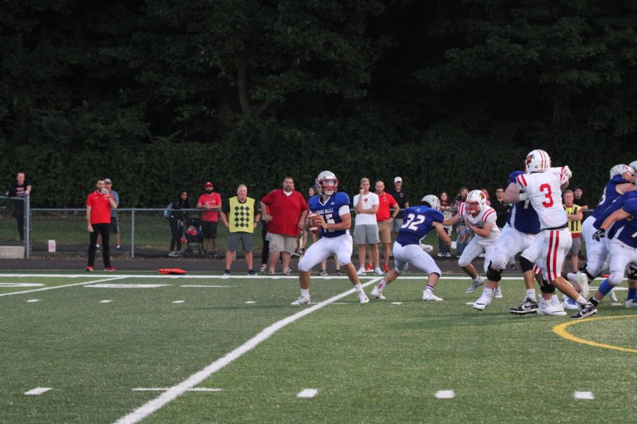 SEARCHING FOR SIX: Aidan Leffler (#15) looks to throw a touchdown pass to Kyle Lockard in week one against Southport, pushing himself further into the record books for most career touchdown passes. The team's week one win against Southport began their journey towards an undefeated regular season.