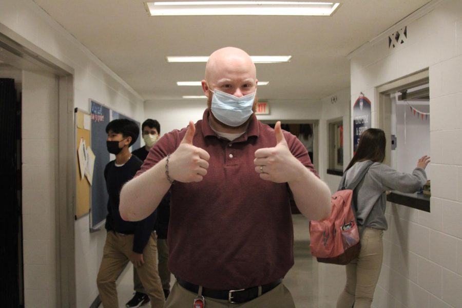 Mask+up+royals%21-+Theology+teacher+Mr.+Normington+poses+with+his+mask+on+at+lunch.+
