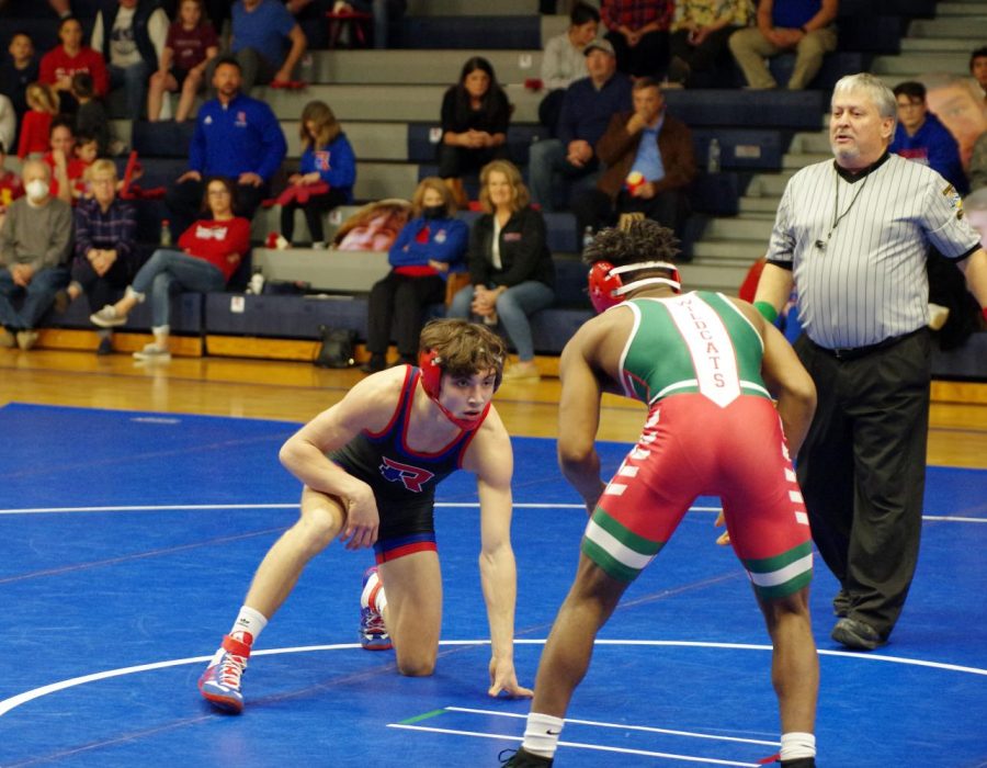 TO THE MAT: Junior Bryce Lowery faces off with Junior Romeo White of Lawrence North on Senior Night in December. Lowery won the match by major decision 10-0  and the Royals won the duel 73-6. 