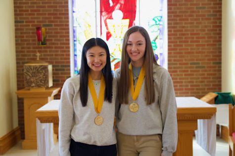BOLD IN GOLD: Seniors Anne Ameis and Katrina Gangstad smile in the chapel after being named the class’s Valedictorian and Salutatorian. The two celebrated the honors they received with their families.