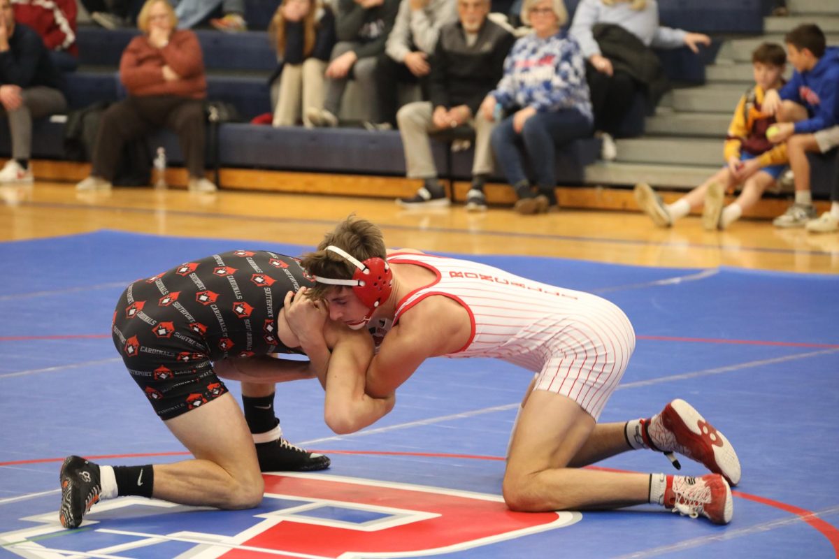 LAST HOME MEET: Wrestling for his last time at his home gym, senior Braden Getz looks to win state. “I am working to stay as healthy as possible to wrestle to the best of my ability. I am also working on endurance to make it through hard matches,” said Getz. 
Photo by John Smith


