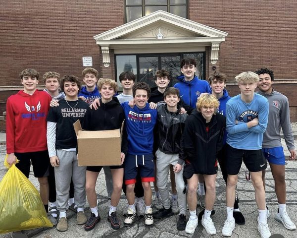 The boys basketball team volunteers at Beggars For the Poor to donate the socks and gloves that were collected.