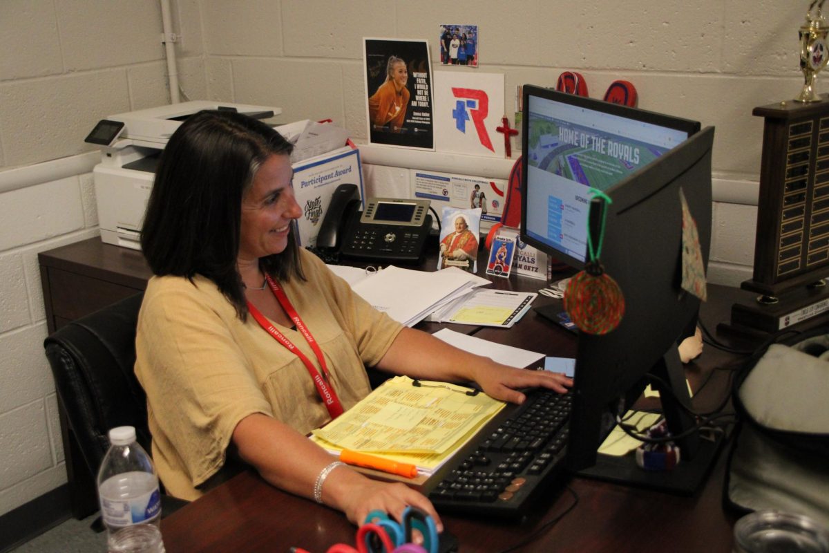 Assistant athletic director Regan Getz looks over the schedules for the upcoming sporting events. “We prioritize what needs to happen today, so we can be better prepared for the future,” Getz said.
