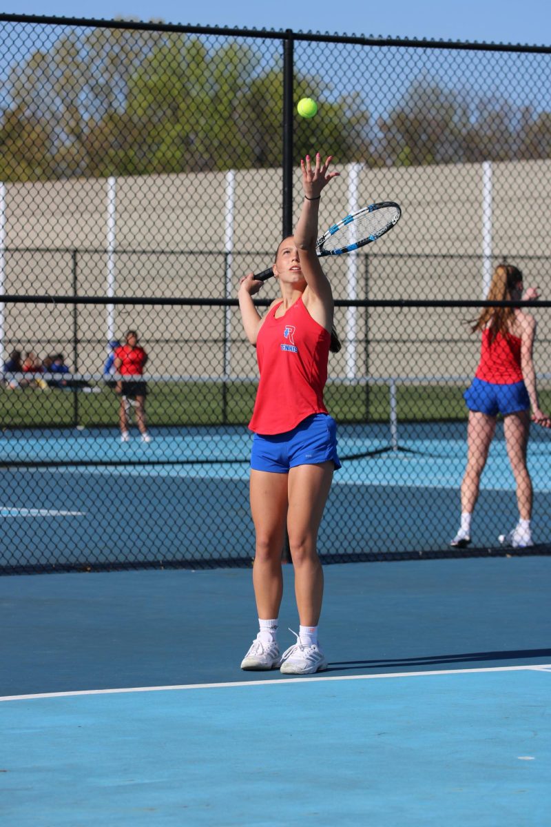 RELEASE: On senior night against Cardinal Ritter, Rebecca Zarkowski throws up the ball for her serve. Zarkowski took home a win in #1 singles. “I think I have improved my mental game this year and kept a positive attitude during a match,” said Zarkowski. 
