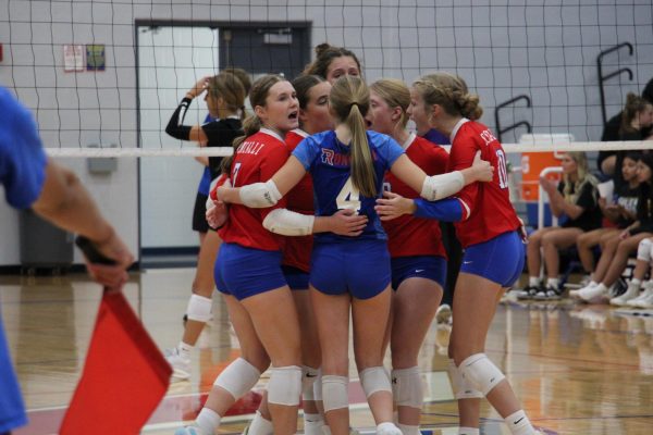 The freshman volleyball team coming together to celebrate after a great play in their game versus Guerin Catholic.