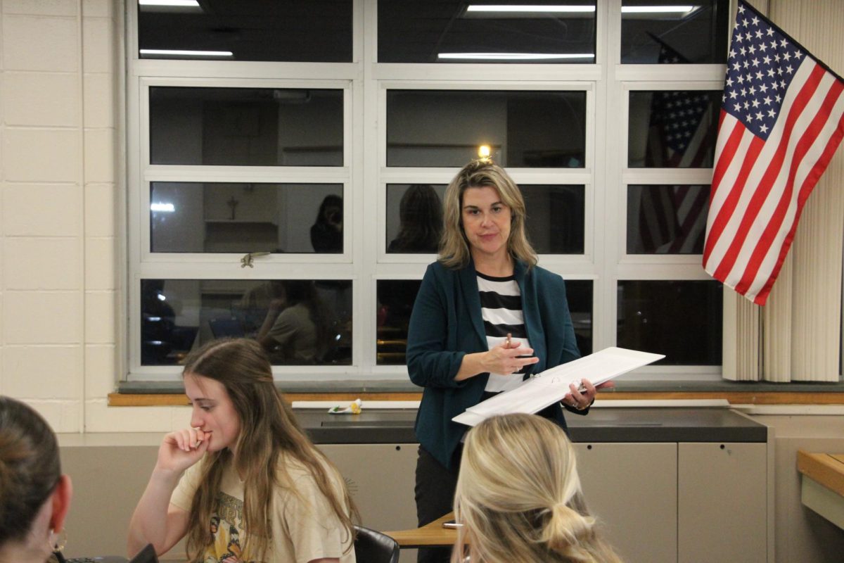 Tiffany Costley, a Mock Trial coach, listens to students during practice.