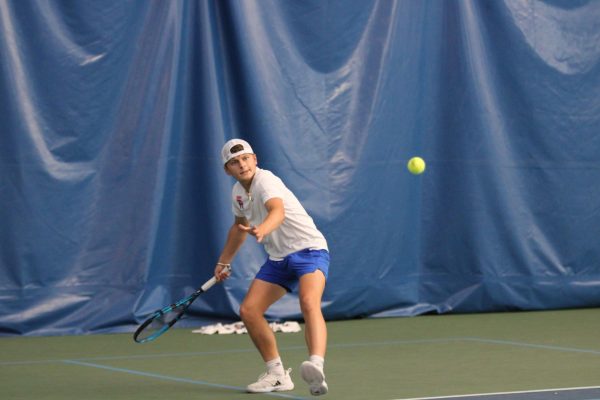 Senior Chris Stanley returns the ball with a forehand. Stanley and his team won 5-0 against Speedway in the Marion County Tournament.