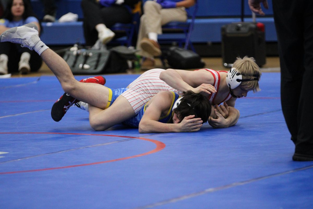 Junior Peyton Schoettle pins his opponent in his match against Greenfield Central.