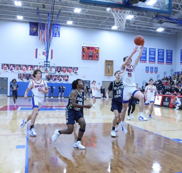 Freshman Reagan Cheesman goes up for a lay in, followed by fellow
freshman, Caleb Maurer. The Roncalli JV basketball team suffered their
first loss of the season in a clash against Decatur Central on December 13.
