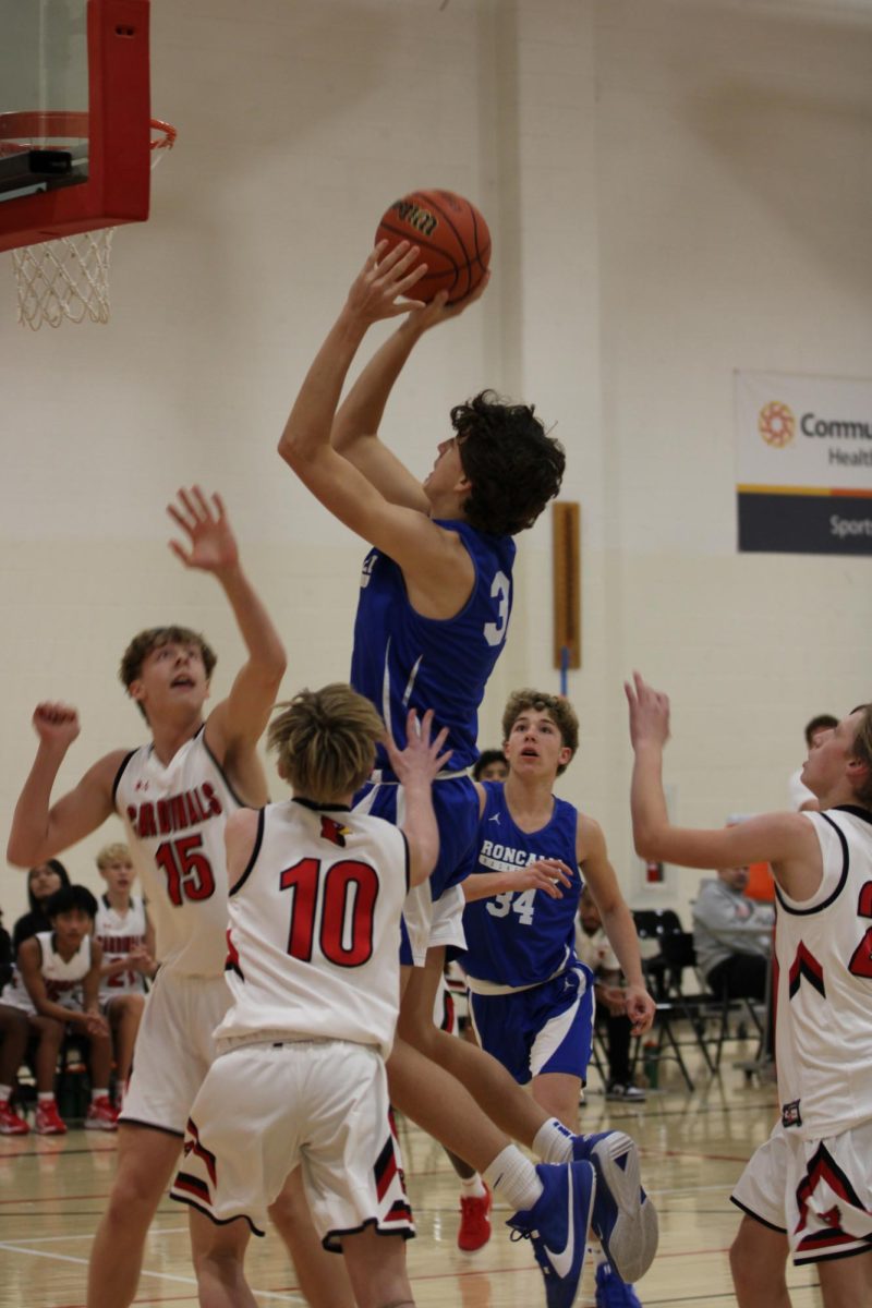 UP FOR THE BASKET: Against the Southport Cardinals, freshman Dane Burton goes up for a shot. “My favorite game of the season has been Decatur Central,”Burton said. “I feel like during this game we played the best basketball we had all season.” 