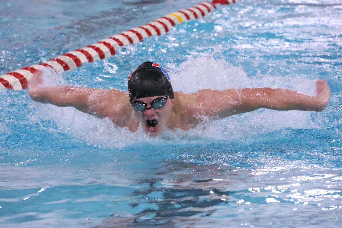 Junior Ben McGaha at Southport wins the 100 Fly and swims season's best in the 100 Back.