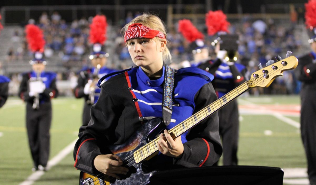 MARCHING ON:  The marching band plays at the home football game against Columbus North during half-time. Senior Delaney Jones is shown playing the electric guitar above. Royals won the game 49-7. 