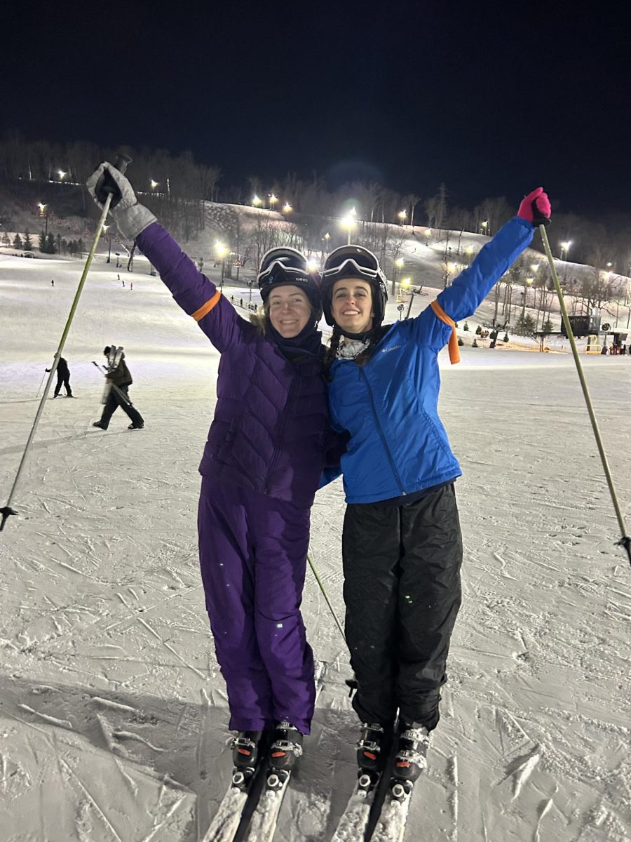 While at Perfect North, seniors Gianna Miller and Lily Bauman pose for a picture at the bottom of the slope together. 