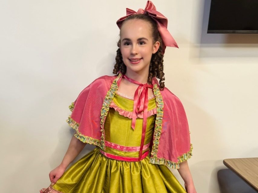 Her dress: Freshmen Audrey Iams is posing for a picture in the dress that she is going to wear in the play.