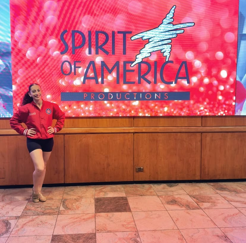 After her arrival at New York, senior Nicole Azar stands in front of a Spirit of America Productions sign. She was one of the six hundred girls chosen nationwide to dance. “I will definitely remember the hard work that it takes, but also the rewarding feeling of walking through the parade and seeing everyone so excited and happy,” Azar said.
